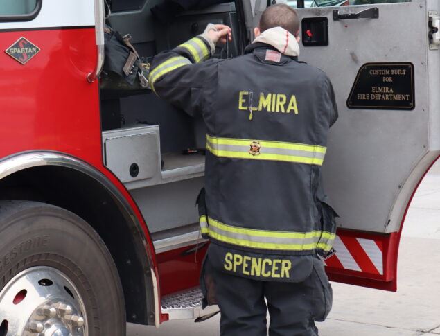 Fire fighter next to fire truck