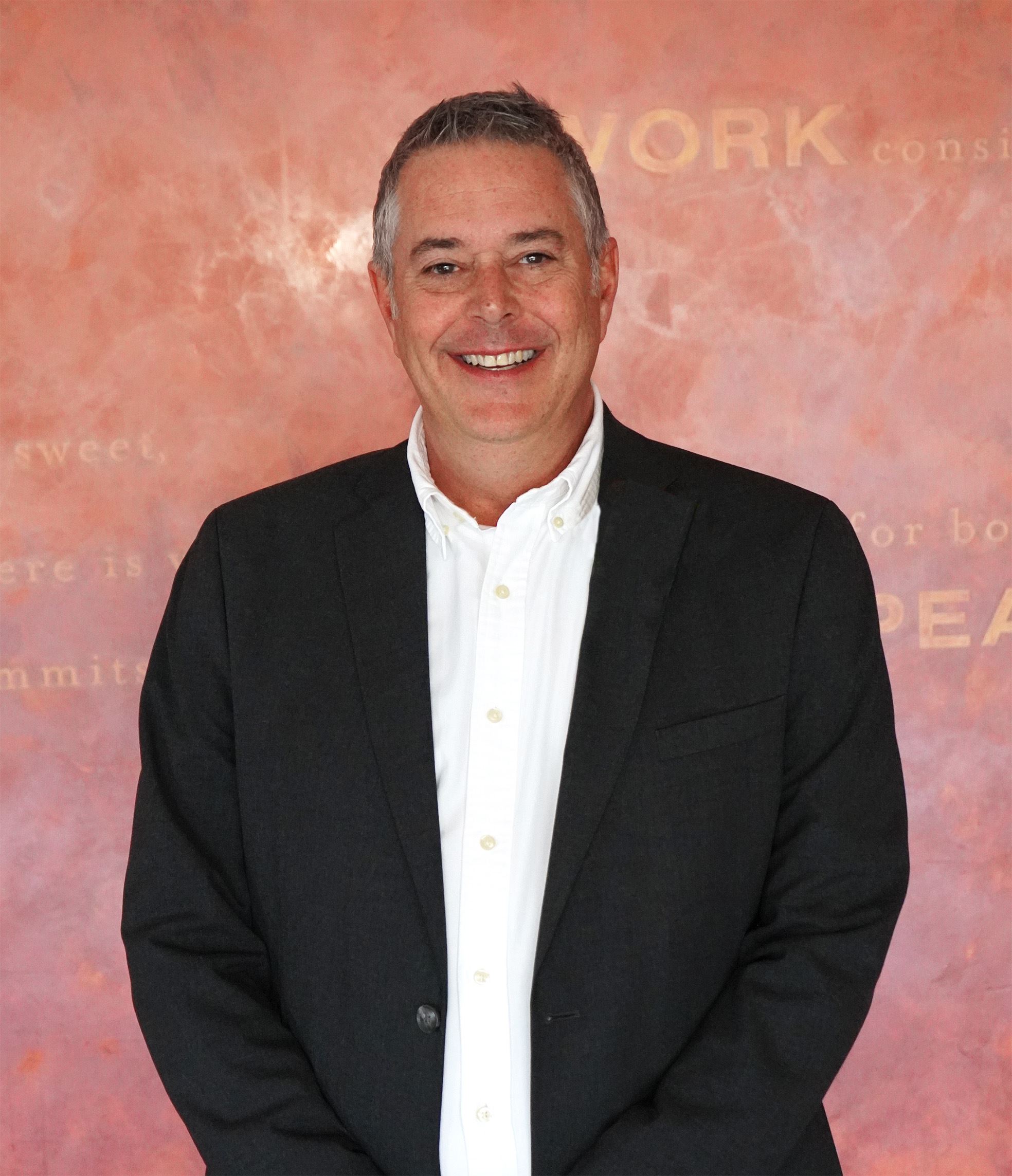 City Manager P. Michael Collins. Tall white male with gray hair in dark gray suit. 