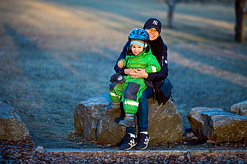 Parent holding child with helmet
