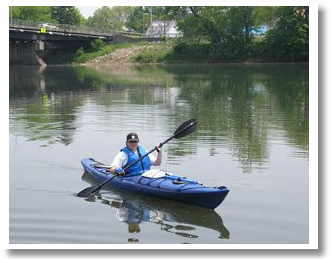 Person Canoeing on River
